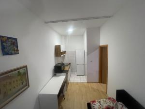 a small white kitchen with a refrigerator in a room at Hideout apartments Travnik in Travnik