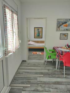 a hallway with a table and a room with a bed at Cyclo Apartment Pinki in Bačka Palanka