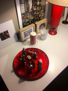 a red plate with chocolates on top of a table at Casa do Mercado in Braga