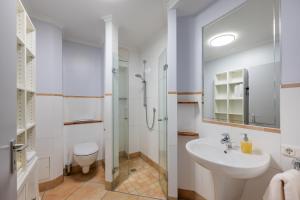 a bathroom with a sink and a toilet and a shower at K & R Appartements Binz in Binz