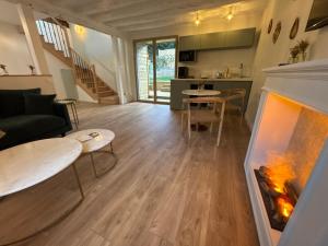 a living room with a fireplace and a couch at Les Eclats d'Amour in Chargé