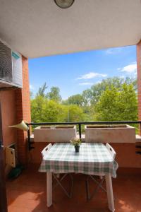 a table and chairs on a balcony with a view at La Casa Blu- Forum di Assago, Humanitas, Milanofiori, IEO in Rozzano