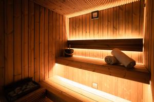 a sauna with wooden walls and a wooden shelf at Hotel Villa España in Benidorm