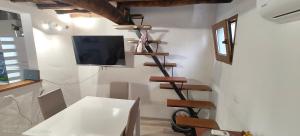 a living room with a tv on a wall at Casina Luce in Stiava