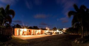 a car parked in front of a house at night at Pialba Motor Inn in Hervey Bay