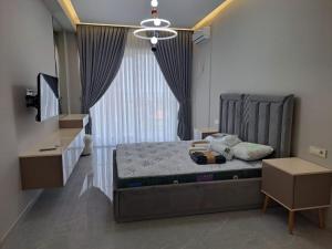 a bedroom with a bed and a large window at Sea Breeze Nardaran open kitchen apartment in Nardaran