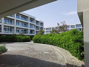 a building with a brick walkway in front of a building at Sea Breeze Nardaran open kitchen apartment in Nardaran