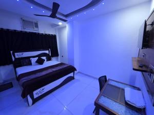 a bedroom with a bed in a room with violet lights at HOTEL ToWNHOUSE in New Delhi