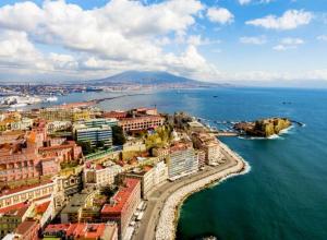 an aerial view of a city next to the ocean at Angioino Central in Naples