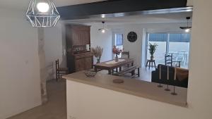 a kitchen and living room with a table and chairs at Maison cosy esprit campagne in Luçon