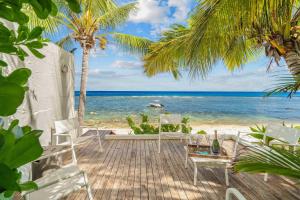a deck with chairs and a view of the ocean at Villa Marea - Exceptional Beachfront Sanctuary in Tamarin