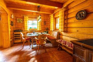 a dining room with a table and chairs in a cabin at Ferienhaus Schachtenbach in Bayerisch Eisenstein
