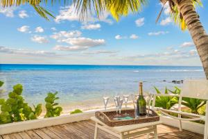 a table with wine glasses on the beach at Villa Marea - Exceptional Beachfront Sanctuary in Tamarin +53 photos