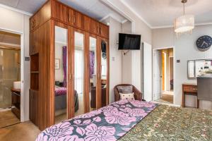 a bedroom with a bed and a desk and a tv at Rivendale Lodge in Port Seton