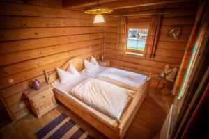a bedroom with a bed in a wooden room at Ferienhaus Schachtenbach in Bayerisch Eisenstein