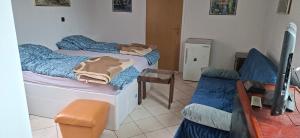 a bedroom with two twin beds and a chair at Apartman Buco in Livno