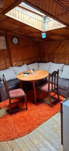 a wooden table and two chairs in a room at Apartman Buco in Livno