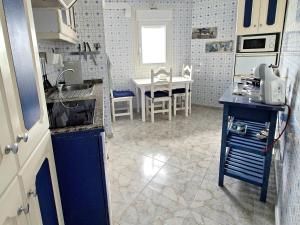 a kitchen with a sink and a table in it at Ocean Whisper suite in Tacoronte