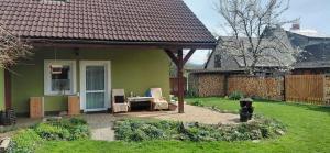 a house with a patio with a table in the yard at Apartmán Hodoňovice in Frýdek-Místek