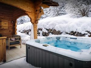 a hot tub in the snow in a cabin at Chalet Roche de Pierre - OVO Network in Saint-Jean-d'Aulps
