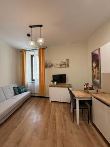 a living room with a couch and a table at Willa nad rzeką in Kłodzko