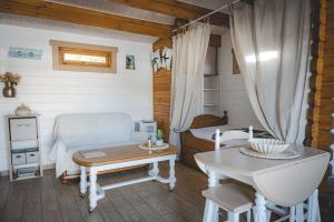 a room with a bed and a table and a tub at Chalet in Le Teich