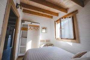 a small bedroom with a bed and a window at Chalet in Le Teich