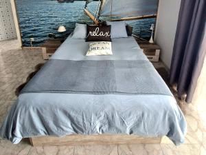 a bed in a room with a view of the water at Ocean Whisper suite in Tacoronte