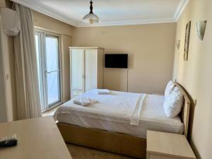 a hotel room with a bed and a window at Dove Apart Hotel in Fethiye +38 photos
