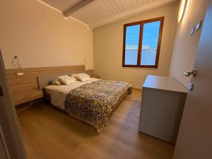 a bedroom with a bed and a window at Luce di Mare in Quartu SantʼElena