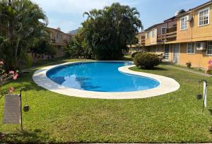 ein Swimmingpool im Hof eines Apartmentkomplexes in der Unterkunft Casa Cayo in Ixtapa