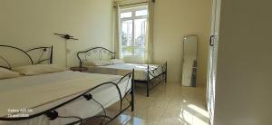 a room with two beds and a window at Life and memory in Blue Bay