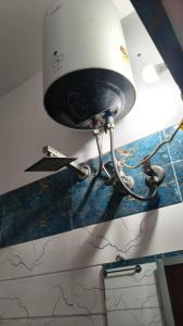 a lamp on top of a counter with a blue counter top at narayan home stay in Ayodhya