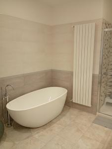 a white bath tub in a bathroom with a shower at Casa Don Peppì in Monopoli +38 photos