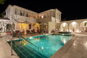 a house with a swimming pool at night at Viento Alacati Hotel in Alaçatı