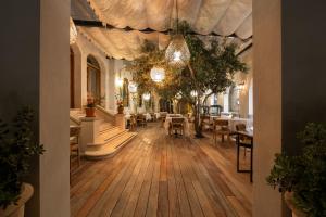 a restaurant with tables and chairs in a room at Viento Alacati Hotel in Alaçatı