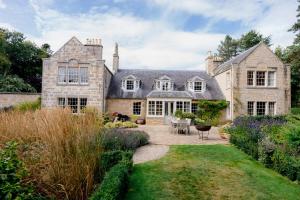 an exterior view of a house with a garden at Binsness house in Findhorn