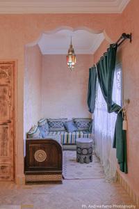 a living room with a couch and a window at Riad Belvedere in Ouzina +72 photos