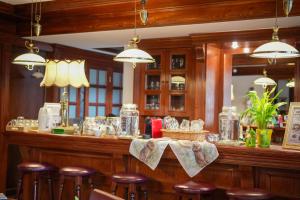 a bar with bar stools at a restaurant at Art'e Boutique Rooms in Băile Tuşnad