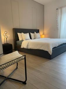 a bedroom with a bed and a chair in it at Casa vacanze Daiva in Arona