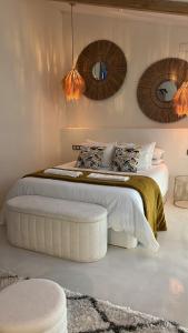 a bedroom with a bed with two mirrors on the wall at Tu Casita Rural in Valdilecha