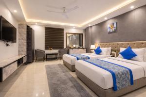 a hotel room with two beds and a television at OPO Horizon Aerocity ,Delhi Airport in Jāmb