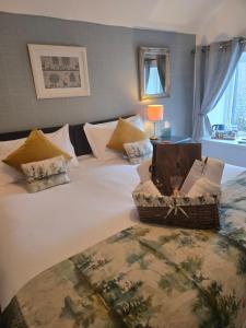a bedroom with a bed with a basket on it at Ardlogie Guest House in Aviemore