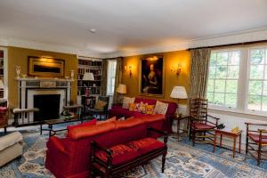 a living room with red couches and a fireplace at Binsness house in Findhorn
