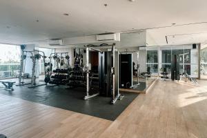 a gym with treadmills and machines in a room at Lavy at Anderson Pakuwon Mall in Surabaya