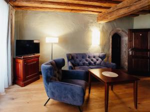 a living room with a couch and a table at Altstadt Hotel Stadtkrug in Salzburg
