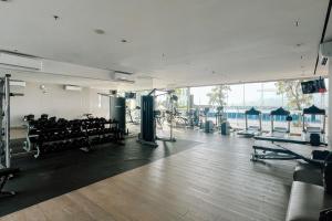 a gym with benches and equipment in a building at Lavy at Anderson Pakuwon Mall in Surabaya