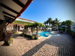 a courtyard with a swimming pool and a building at Punta Blanca Ocean Suites in Santa Elena