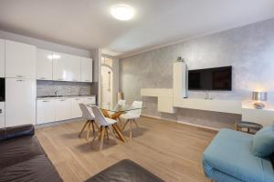 a living room with a couch and a table and chairs at La Casa Del Tasso in Feriolo