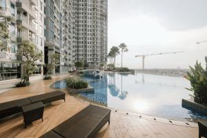 a large swimming pool in the middle of a building at Lavy at Anderson Pakuwon Mall in Surabaya